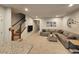 Cozy living room with a sectional sofa, mounted TV, staircase, and view into the entryway at 205 Grand Palm Ln, Summerville, SC 29485