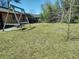 Spacious backyard featuring a swing set, lush lawn, and mature trees at 205 Longstreet St, Summerville, SC 29486