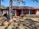 Charming single story home featuring a brick facade, covered porch, and mature landscaping at 205 Longstreet St, Summerville, SC 29486