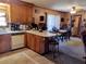 Open kitchen area with wood cabinetry, tiled flooring, and breakfast bar seating overlooking the dining area at 205 Longstreet St, Summerville, SC 29486