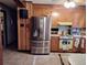 Kitchen featuring stainless steel refrigerator, wood cabinets, and tiled flooring in a functional layout at 205 Longstreet St, Summerville, SC 29486