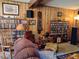 Inviting living room with wood paneling, a large collection of books and music, and cozy seating at 205 Longstreet St, Summerville, SC 29486