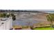 Backyard of home with fenced-in lawn, landscaping, and marsh view at 23 Lowndes Pointe Dr, Charleston, SC 29403