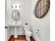 Elegant half bathroom featuring pedestal sink, updated fixtures, and stylish decor at 23 Lowndes Pointe Dr, Charleston, SC 29403