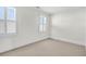 Minimalist bedroom features neutral walls, plush carpet and plantation shuttered windows at 23 Lowndes Pointe Dr, Charleston, SC 29403
