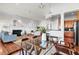 Open dining room with glass table and a view into the living room with fireplace and kitchen at 23 Lowndes Pointe Dr, Charleston, SC 29403