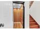 Interior elevator with wood paneling conveniently located next to a wooden staircase in the home at 23 Lowndes Pointe Dr, Charleston, SC 29403