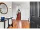 Bright foyer with hardwood floors, staircase, black accent table, and a view from the open front door at 23 Lowndes Pointe Dr, Charleston, SC 29403