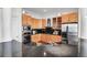 Well-equipped kitchen featuring stainless steel appliances, wood cabinetry and granite countertops at 23 Lowndes Pointe Dr, Charleston, SC 29403