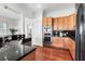 Well-equipped kitchen with stainless steel appliances, wood cabinets, and black granite countertops at 23 Lowndes Pointe Dr, Charleston, SC 29403