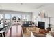 Comfortable living room with fireplace and access to sun room with beautiful marsh view at 23 Lowndes Pointe Dr, Charleston, SC 29403