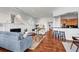 Sunlit open living room with hardwood floors, fireplace, stylish furnishings, and views into the kitchen at 23 Lowndes Pointe Dr, Charleston, SC 29403