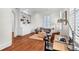 Bright living room with built-in shelves, hardwood floors, and large windows with plantation shutters at 23 Lowndes Pointe Dr, Charleston, SC 29403