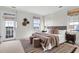 Inviting bedroom with balcony access, soft rug, upholstered bed, and scenic views from multiple windows at 23 Lowndes Pointe Dr, Charleston, SC 29403