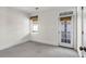 Bright room featuring carpet, window, and exterior door leading to a balcony, and neutral color palette at 23 Lowndes Pointe Dr, Charleston, SC 29403