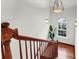 Bright staircase with wood railing and hardwood floors leading to the upper level at 23 Lowndes Pointe Dr, Charleston, SC 29403