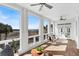 Well-lit sun room with ceiling fans and scenic view of the marsh at 23 Lowndes Pointe Dr, Charleston, SC 29403