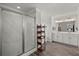 Bright bathroom showcasing a glass shower, double sinks, and a freestanding shelf for storage at 2690 Park W Blvd, Mount Pleasant, SC 29466