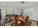 Elegant dining area with wood table, set for six, and a view into the spacious living room at 2690 Park W Blvd, Mount Pleasant, SC 29466