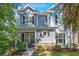 Charming blue two-story home with black shutters and brick accents, surrounded by lush landscaping at 2690 Park W Blvd, Mount Pleasant, SC 29466