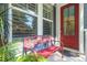 Cozy front porch with red decorative bench, offering a welcoming entrance to the home at 2690 Park W Blvd, Mount Pleasant, SC 29466