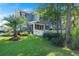 Charming two-story home featuring a white picket fence, a screened porch, and a lush lawn with mature trees at 2690 Park W Blvd, Mount Pleasant, SC 29466