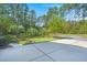 Well-manicured front yard with lush green grass, mature trees, professional landscaping and a spacious driveway at 2690 Park W Blvd, Mount Pleasant, SC 29466