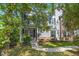 Charming home exterior with manicured lawn, mature trees, and a welcoming entrance with landscaping at 2690 Park W Blvd, Mount Pleasant, SC 29466