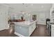 Bright, open kitchen features a large island, stainless appliances, and seamless flow to the dining and living areas at 2690 Park W Blvd, Mount Pleasant, SC 29466