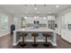 Modern kitchen island with stylish stools, quartz countertop, and stainless steel appliances at 2690 Park W Blvd, Mount Pleasant, SC 29466