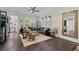 Well-lit living room with hardwood floors, plantation shutters, and comfortable seating arrangement at 2690 Park W Blvd, Mount Pleasant, SC 29466