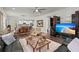 Open-concept living room with hardwood floors, ceiling fan, and seamless flow to dining and kitchen at 2690 Park W Blvd, Mount Pleasant, SC 29466