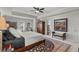 Bright main bedroom featuring a large window, tray ceilings, and a decorative rug at 2690 Park W Blvd, Mount Pleasant, SC 29466