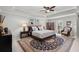 Spacious main bedroom with a large rug, tray ceiling, fan, and ample natural light at 2690 Park W Blvd, Mount Pleasant, SC 29466