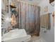 Bathroom featuring a vibrant floral shower curtain, sink, toilet and towel rack at 29 Wendy Lane, Charleston, SC 29407