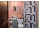 Pink bathroom with a sink, toilet, and a patterned shower curtain at 29 Wendy Lane, Charleston, SC 29407