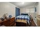 Modest bedroom featuring a plaid comforter, wood-look flooring, and ample natural light at 29 Wendy Lane, Charleston, SC 29407