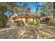 Charming single-story home with a cozy front yard shaded by mature trees and a classic brick chimney at 29 Wendy Lane, Charleston, SC 29407