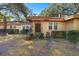 Charming single-story home with mature trees, a brick pathway, and classic front door at 29 Wendy Lane, Charleston, SC 29407