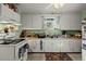 Bright kitchen with white cabinets, stainless steel sink, and a view from the window at 29 Wendy Lane, Charleston, SC 29407