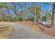 Paved walking path surrounded by mature trees and lush greenery at 29 Wendy Lane, Charleston, SC 29407