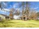 The expansive backyard shows the house, large lawn, mature trees, and fenced boundary at 2901 Newport Pl, North Charleston, SC 29420