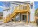 View of the house exterior with a raised wooden deck and stairs leading to the yard at 2901 Newport Pl, North Charleston, SC 29420