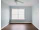 This is a simple bedroom with hard surface floors, blue walls, and a ceiling fan at 2901 Newport Pl, North Charleston, SC 29420