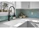 A close up of a kitchen sink with a black faucet and teal backsplash at 2901 Newport Pl, North Charleston, SC 29420