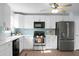 Bright kitchen featuring white cabinetry, stainless steel appliances, and a beautiful teal backsplash at 2901 Newport Pl, North Charleston, SC 29420