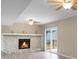 Bright living room with stone fireplace, ceiling fan, and sliding glass doors at 2901 Newport Pl, North Charleston, SC 29420