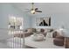 Cozy living room featuring a ceiling fan, large window, and plush L-shaped sofa at 2901 Newport Pl, North Charleston, SC 29420