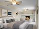 A stylish main bedroom featuring a stone fireplace, ceiling fan and modern decor at 2901 Newport Pl, North Charleston, SC 29420