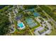 Aerial view of tennis courts and swimming pool along with clubhouse, parking and green landscaping at 2975 Yachtsman Dr, Mount Pleasant, SC 29466